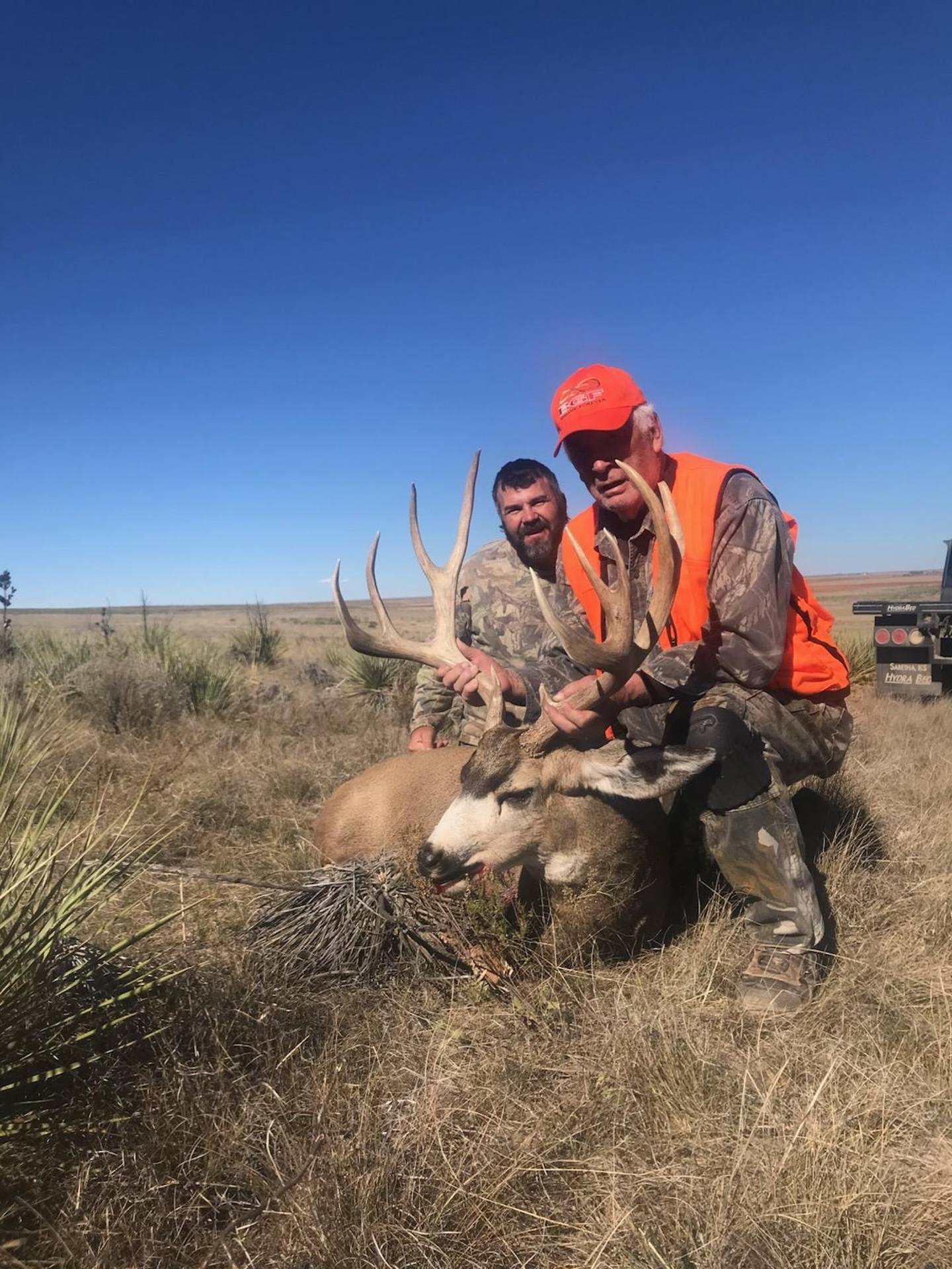Guide and hunter with a mule deer buck on the Eastern Plains