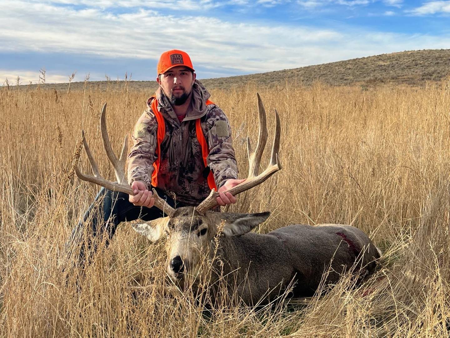 Hunter with a mule deer buck on Colorado's Eastern Plains