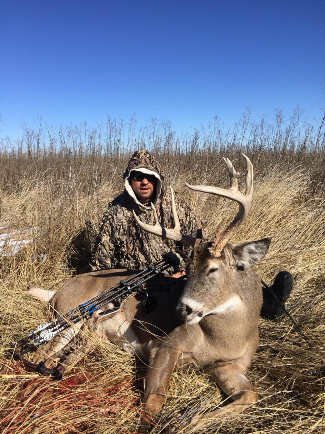 Archery hunter with a whitetail buck